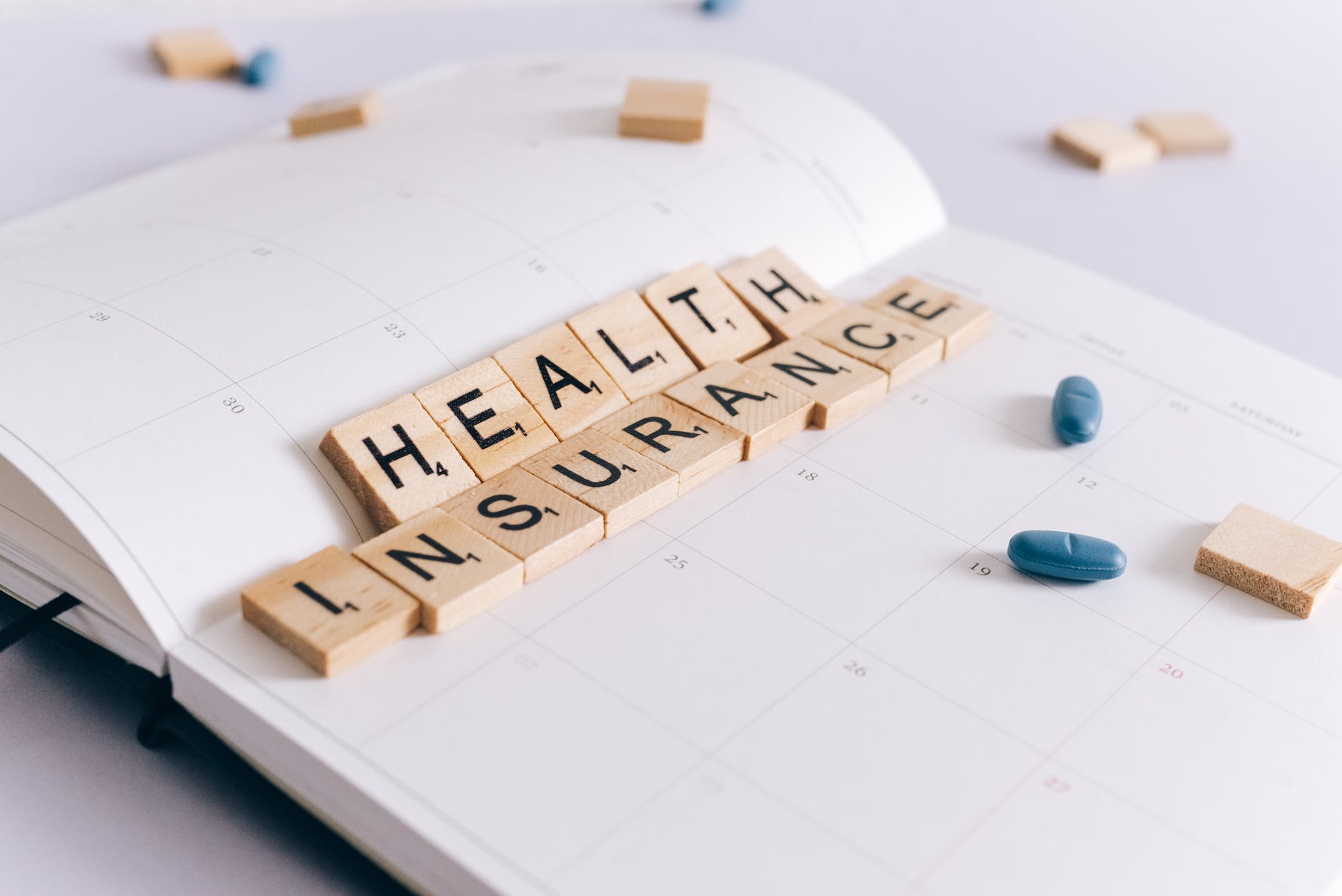 health insurance scrabble tiles on planner